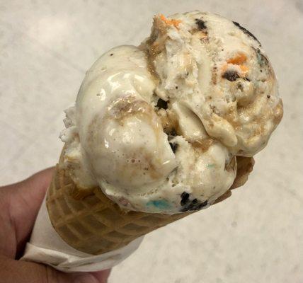 Munchie Madness Sweet cake batter ice cream swirled with a salted caramel ripple with Oreos, M&M pieces and peanut butter cups.