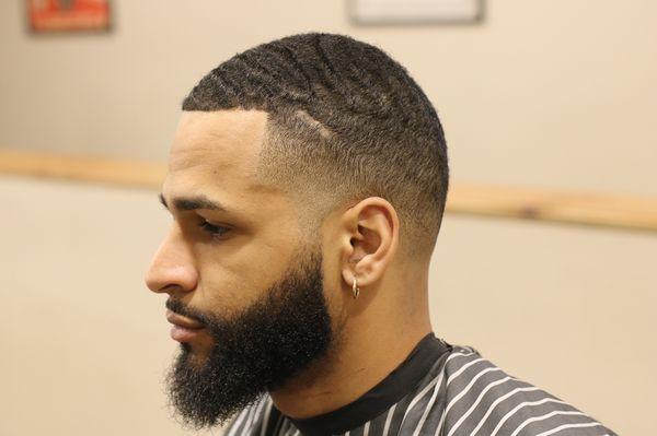 Wave cut with high tapered sides along with beard line up