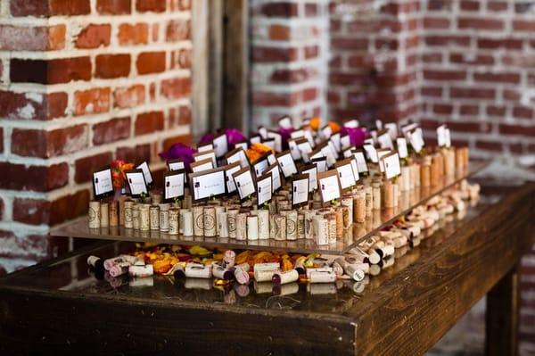 Escort card "corkscape" - we collected corks from various wineries. Mandy affixed them to plexiglass covered w/ of petas/candle!