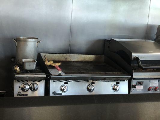 An employee was warming up their own, brought-from-home lunch on the grill used to prepare food for customers.