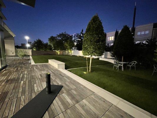 Outdoor deck, lawn, and garden seating.