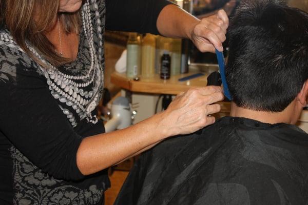 Lori perfecting a Men's haircut