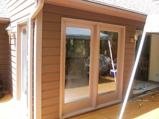 Fixed door slabs with custom PVC frames and pressure treated sills.  Installed & painted by our crew.