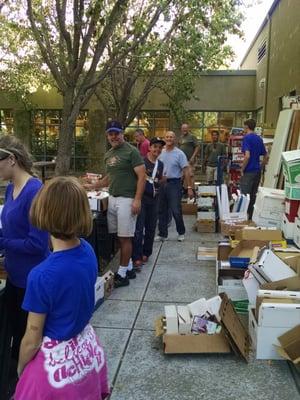 Volunteers packing boxes of books to send to Kenya.