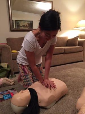 Giving CPR to an adult.