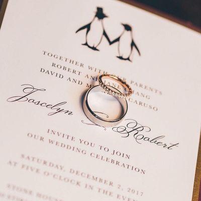 Winter wedding invitation featuring a "penguins in love" theme