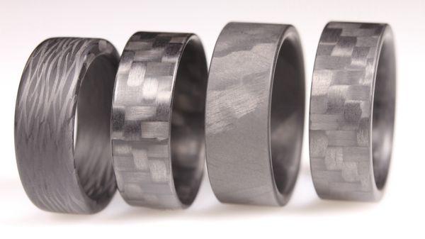 Four of our most popular Carbon Fiber Rings. Handmade in our Millcreek shop.