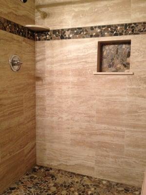 Our beautiful marble, stone, and rock tile bathroom!