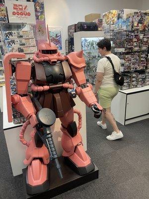 A Zaku II sets the stage for a transcendent, wall-to-wall gunpla kit shopping experience!