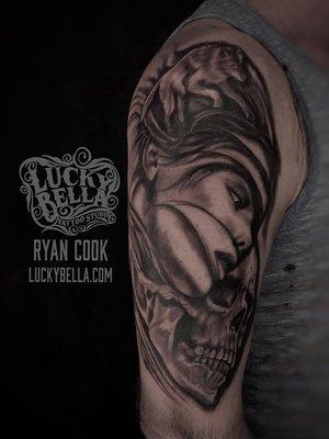 Black and gray woman's face and skull by Ryan Cook