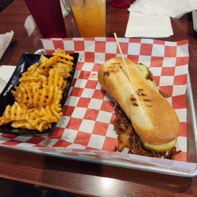 Pulled pork sandwich with waffle fries