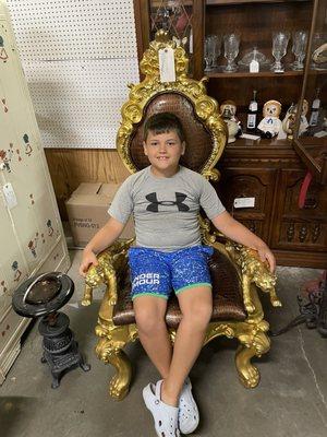 My handsome son sitting in a unique chair.