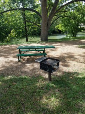 Picnic tables and grills along the creek