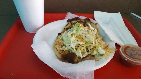 Two pupusas filled with beans and cheese with Tamarindo drink. Really authentic taste and environment.