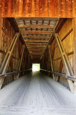 Timber bridge with timber decking spans 155.5 feet, is 22.5 feet high (16.75 inside clearance), and 14 feet wide