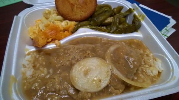 Smothered pork chop with rice, mac & cheese, and okra and cornbread.