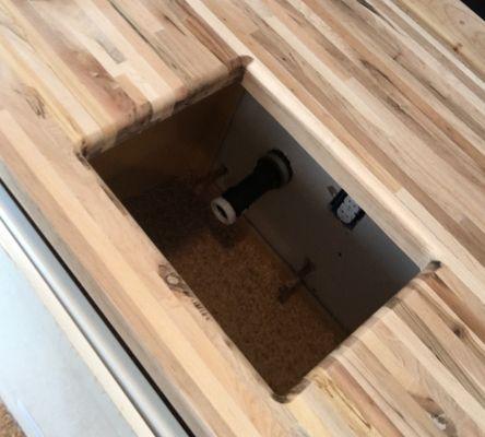 Custom butcher block countertop with underslung sink design.