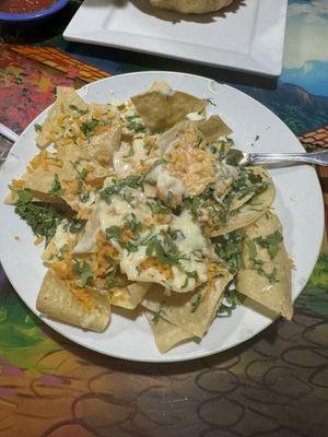 Cheese nachos with rice and cilantro.