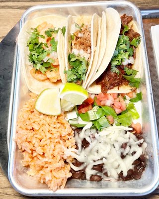 3 TACO COMBO- Barbacoa Pulled Beef, Chicken, and Shrimp Tacos. Served with rice and beans.