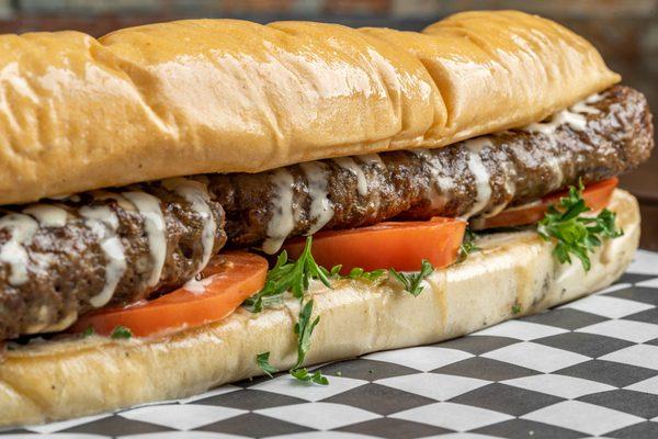 Beef Long Snapper:
Marinated ground beef with oriental spices grilled on skewers, tahini dressing, tomatoes and parsley.