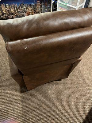 Ripped leather recliner.