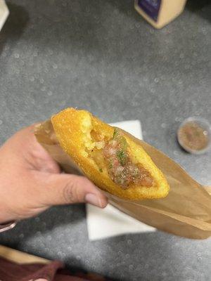 Empanada criolla with salsa on it