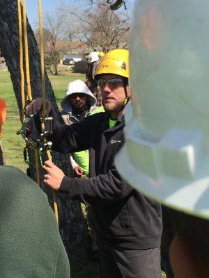 Expert climbing instructor demonstrates newest technologies in tree ascension.