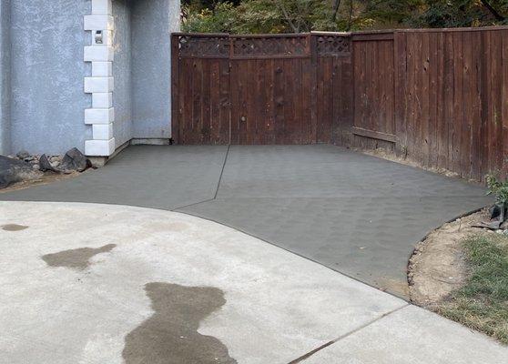 Freshly poured concrete for the patio area.