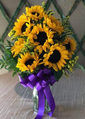 9 Sunflowers in a vase.