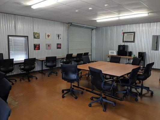 Conference Room: equipped with HDMI and DVD hook-ups, a large TV and sound system for presentations, and a whiteboard for brainstorming.