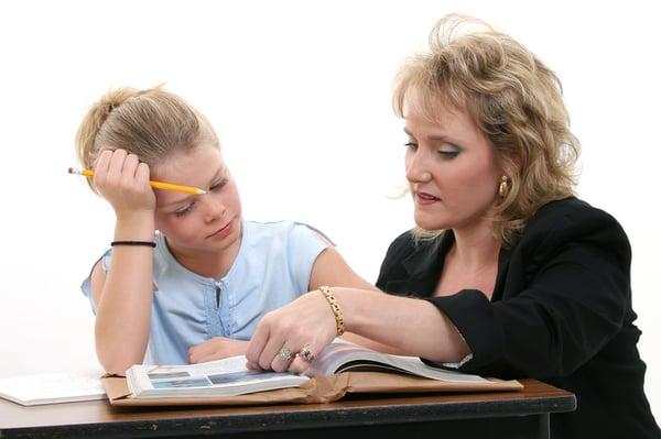 Tutor helping student in home