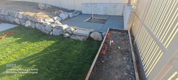 Sod Install flower bed install and c Boulders and concrete pad