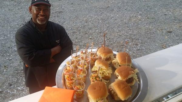 Marvin and a tray of sliders and appetizers.