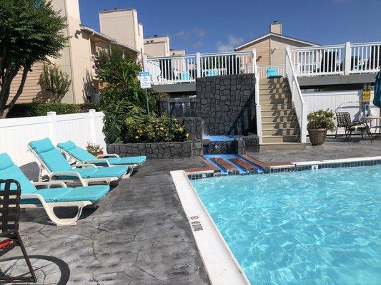 6/15/20. Late Monday afternoon. Pool area in the complex. A code and a bracelet required for each guest to gain entry. Stairs to sun deck.