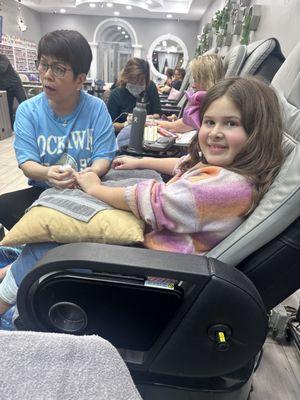 My daughter getting a pedicure and manicure