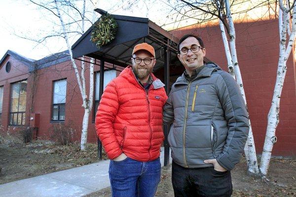 Lead Pastors Justin Barney and Albie Powers standing in front of the Elm City Church building.