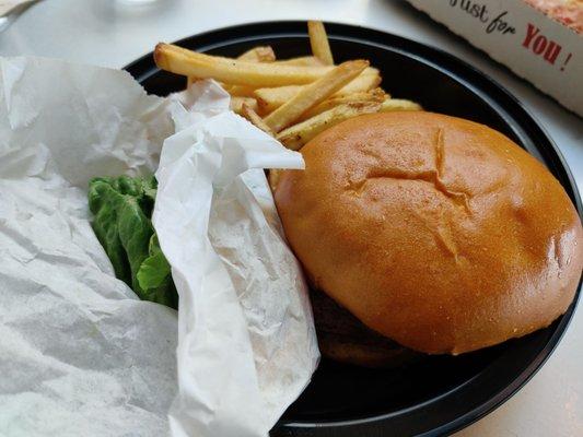 Burger with condiments and accoutrements on the side