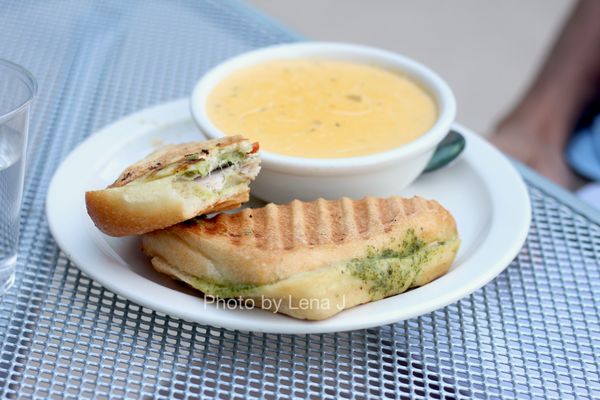 Turkey Pesto Melt with Wisconsin Cheddar Soup ($12.28) - Turkey, sliced tomato, pesto, and Swiss cheese, grilled on a ciabatta roll.