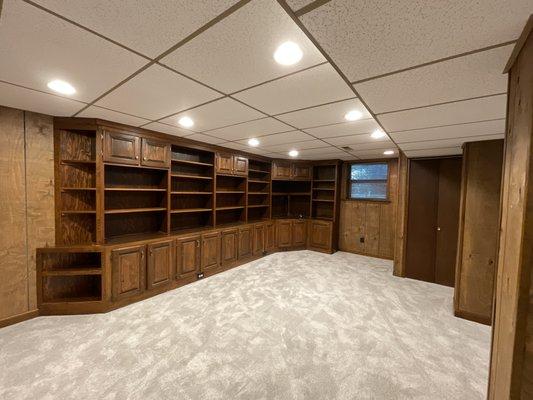 Freshly polished wood bookcase and new carpet for the basement of this listing.