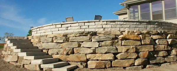 Greenville Retaining Wall Using Local Limestone Outcroppings with Fond du Lac Split-Faced Wall Stone and Steppers.