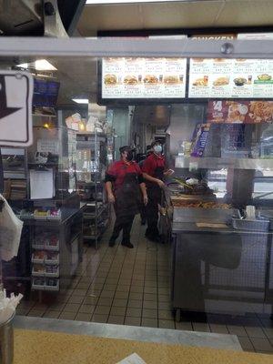 Picture of whoever she was trying to hide her face behind one of the cooks. Wearing a gray hat and a gray t-shirt uniform!