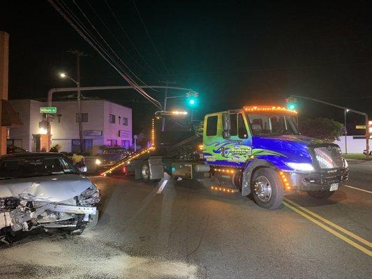 Our tow trucks at night at an accident scene.