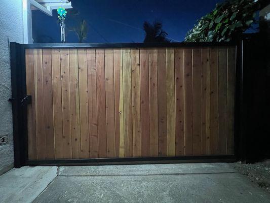 Beautiful steel framed gate with vertical redwood planks