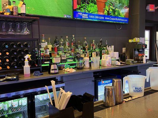 Bar. Cleaners by salt and sugar rimming container. Herbs left out. Open containers that should be back in the coolers. Get it together.