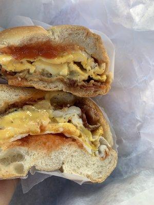 Bacon egg (fried) and cheese with heavy pepper and ketchup on a roll.