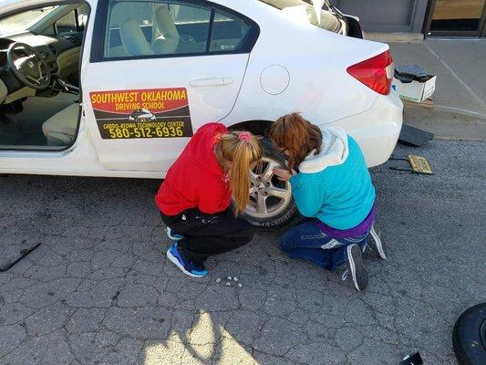 All students learn to change a flat!