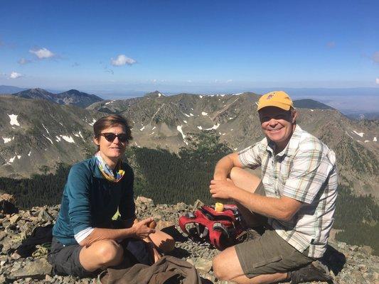 Amy Franklin and Chris Pieper sit atop New Mexico's highest mountain, Wheeler Peak.