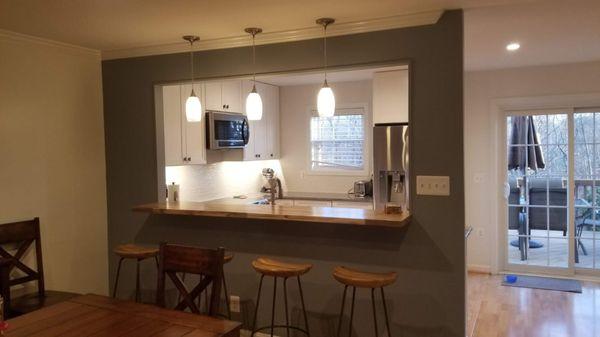 Opening the wall for the Breakfast Bar gave the kitchen more light and looks much bigger