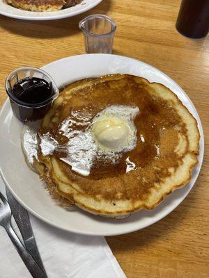 Two stack pancakes with warm syrup.