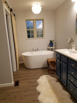 Bathroom makeover - free standing tub, new vanity counter sinks and faucets, new LVT floor and barn slider.